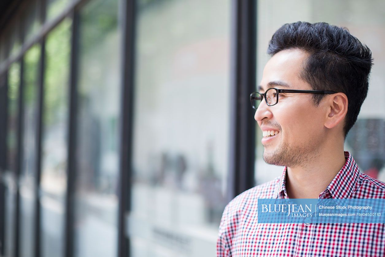 Mid adult Chinese man thinking