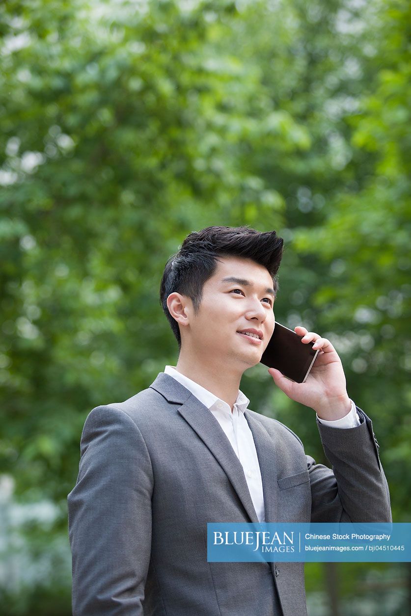 Young Chinese businessman talking on the phone