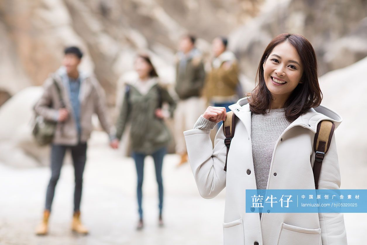 Portrait of cheerful young Chinese woman outdoors in winter