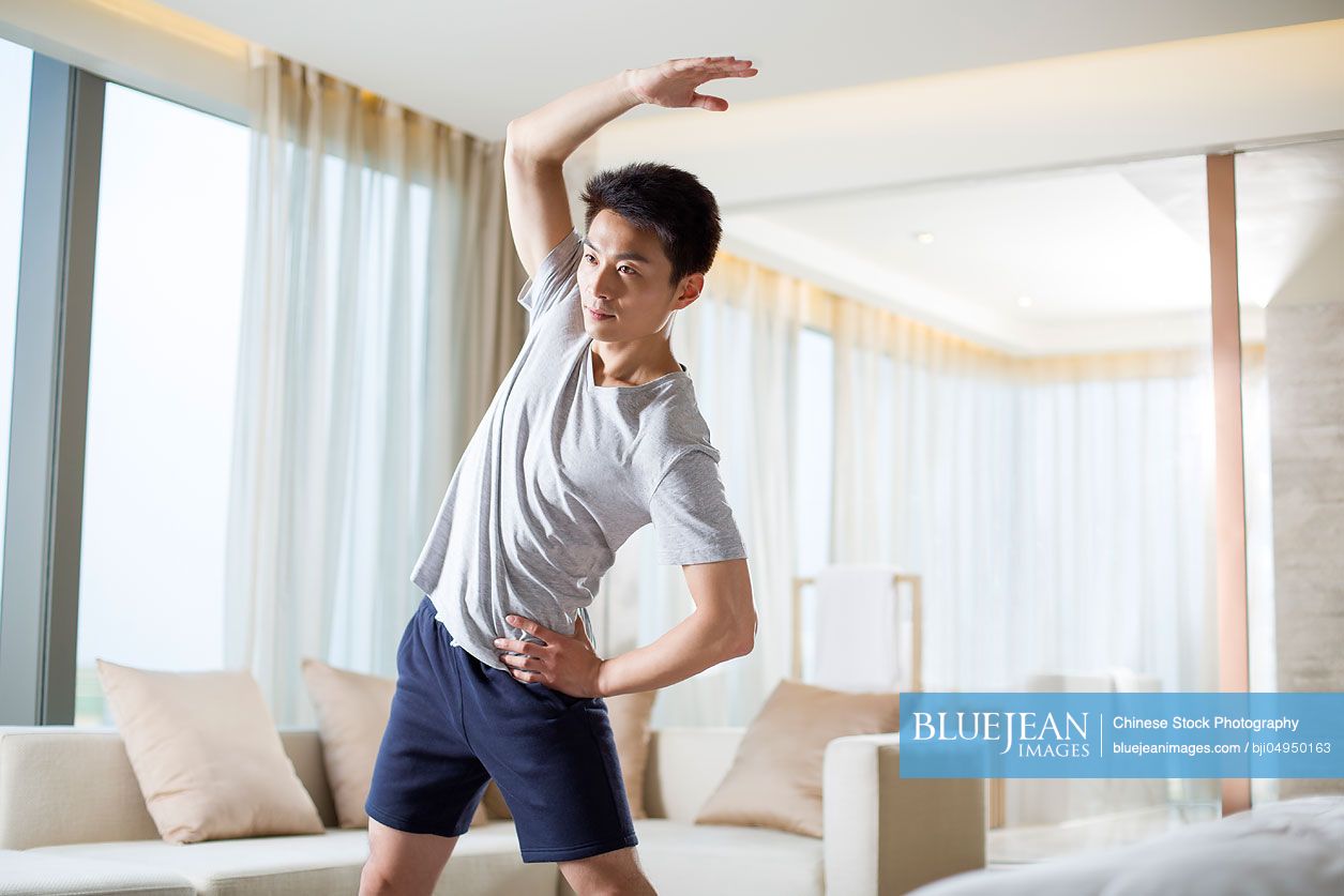 Young Chinese man exercising at home