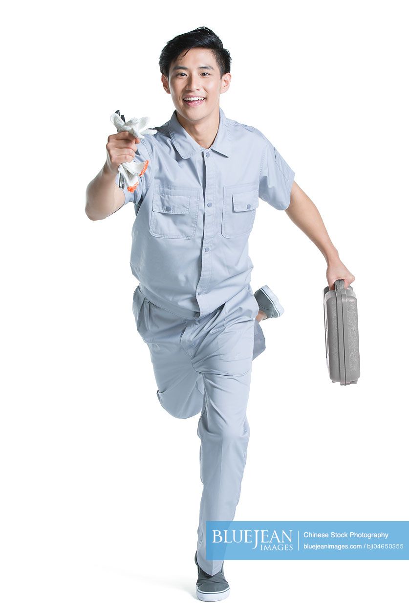 Chinese repairman running with toolbox
