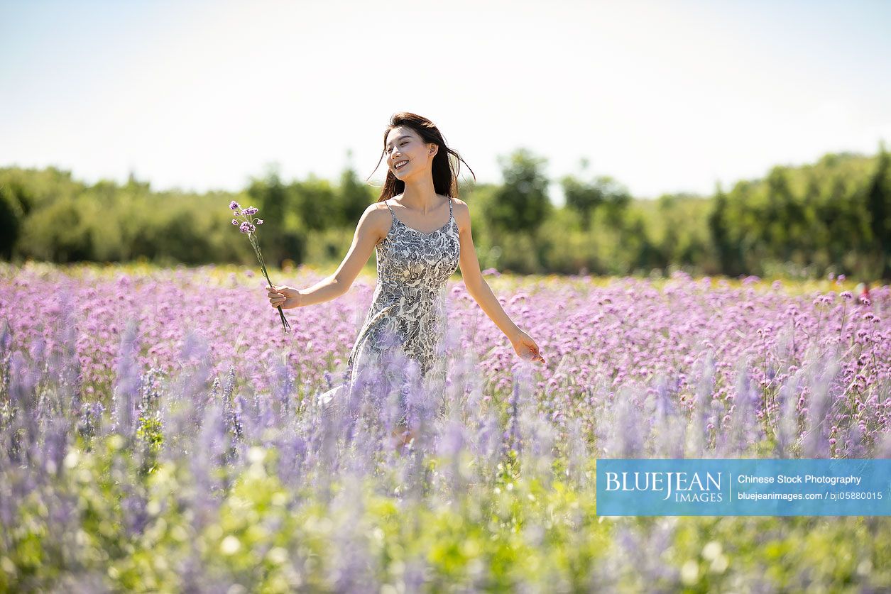 Happy young Chinese woman in lavender field