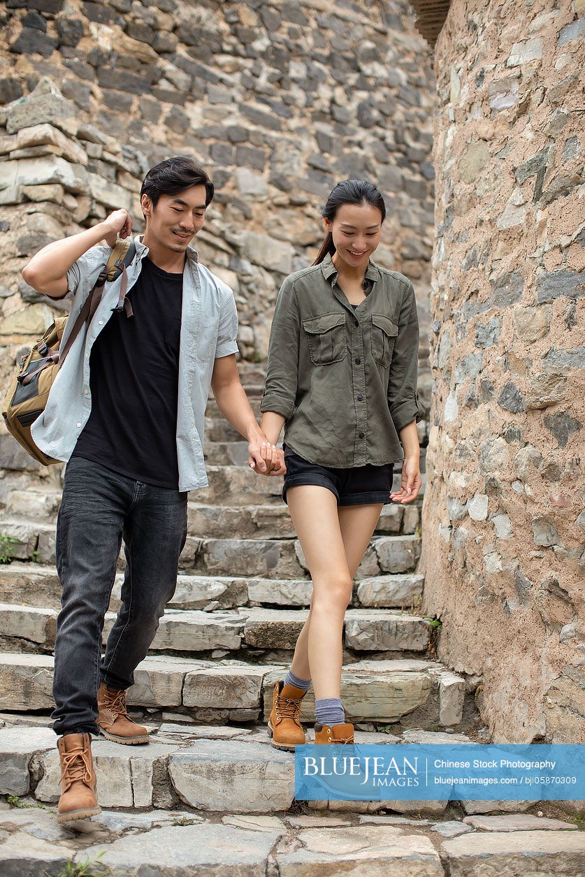 Young Chinese couple hiking in village