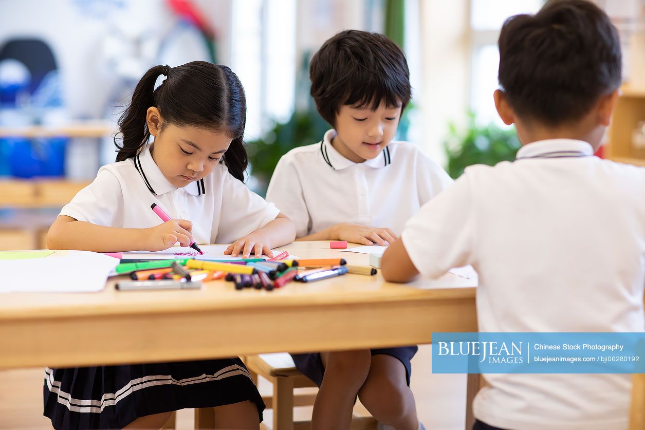 Chinese children painting in classroom