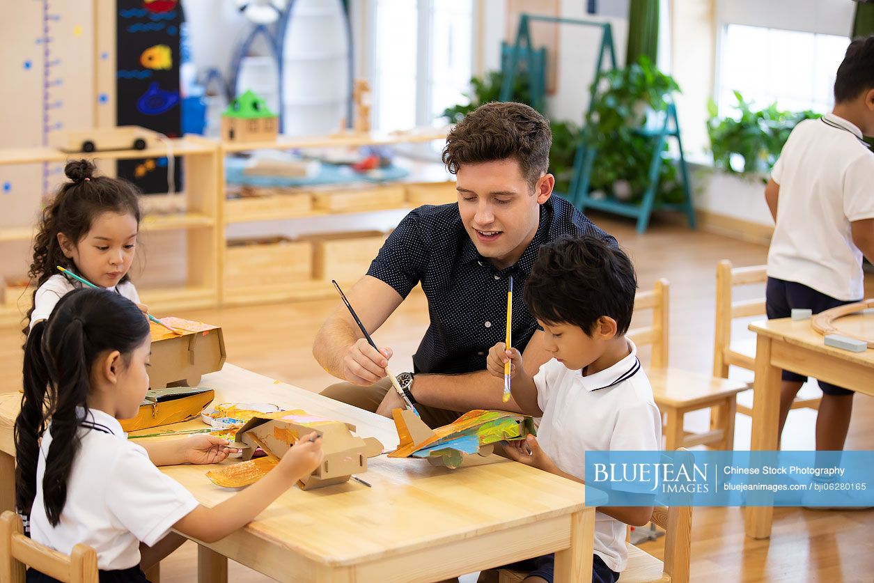 Foreign teacher teaching art class in classroom