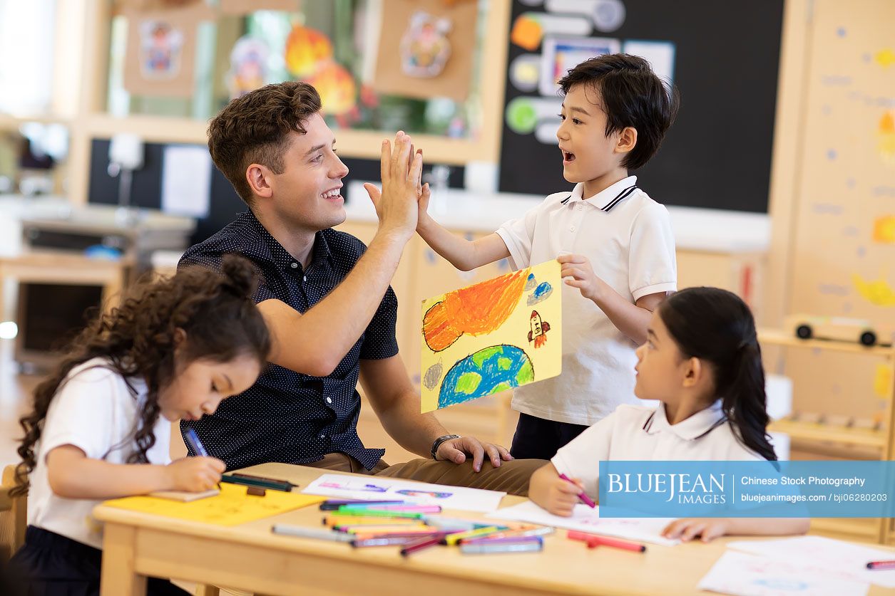 Foreign teacher teaching art class in classroom