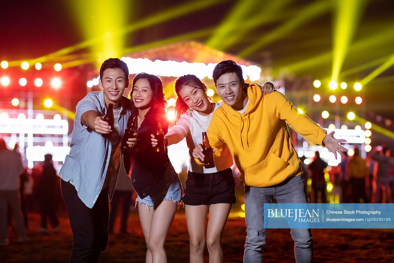 Happy young Chinese friends at music festival
