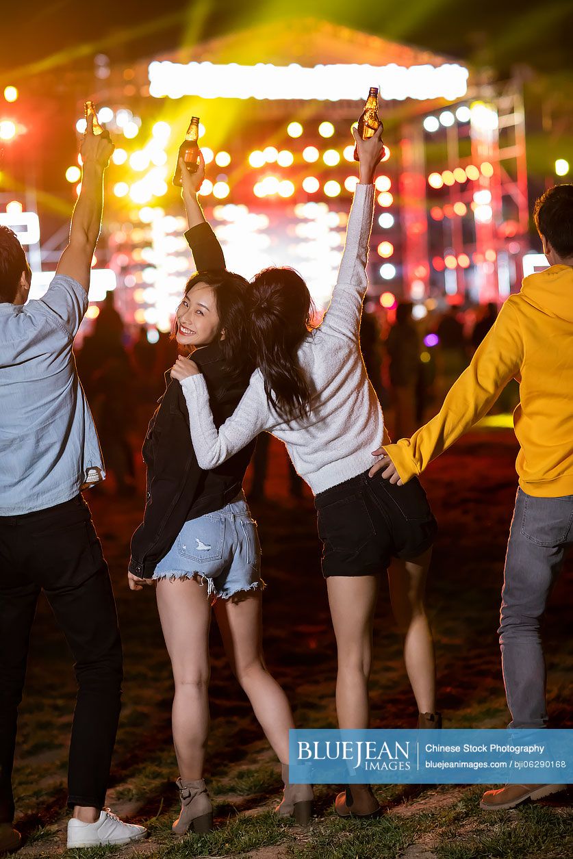 Happy young Chinese friends at music festival