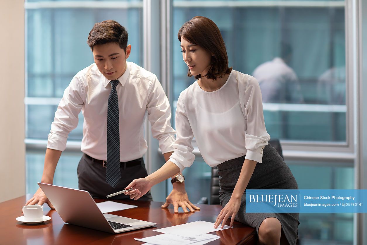 Chinese business people talking in office