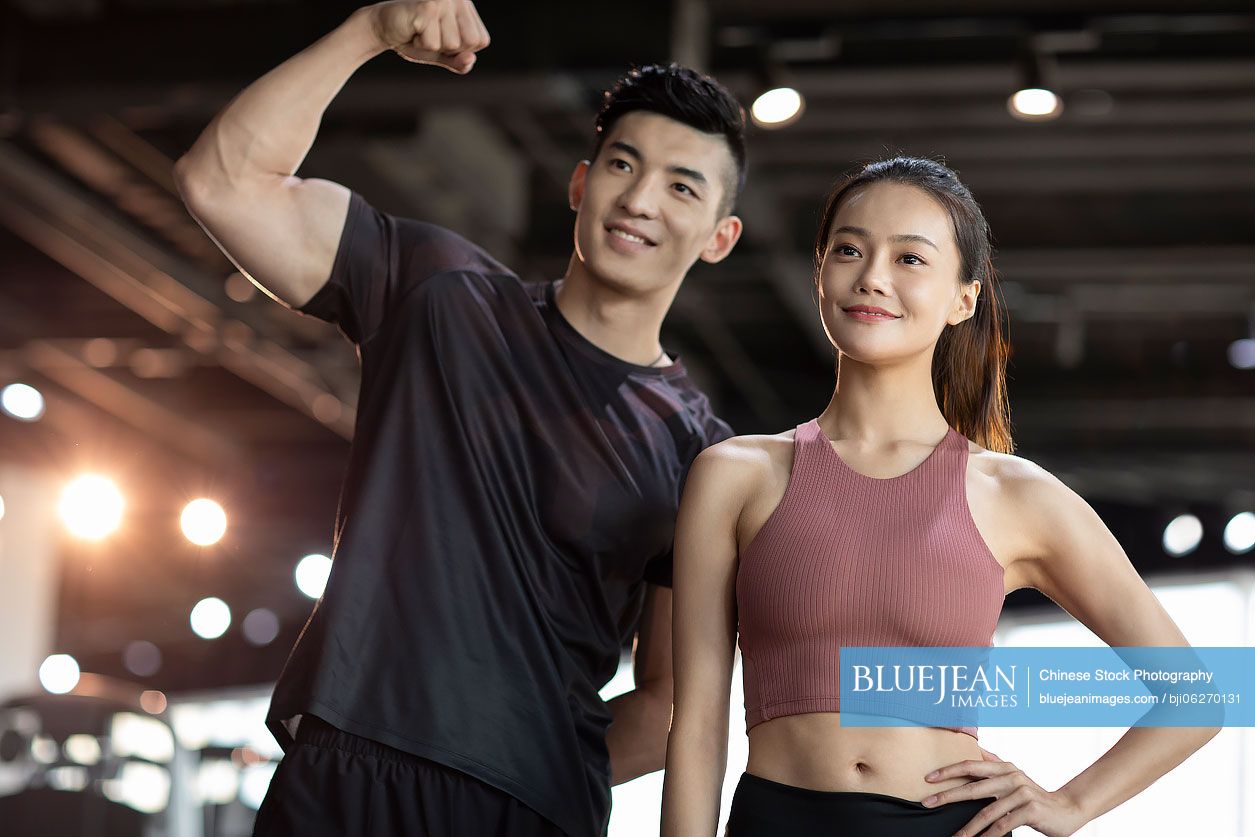 Young Chinese couple exercising at gym