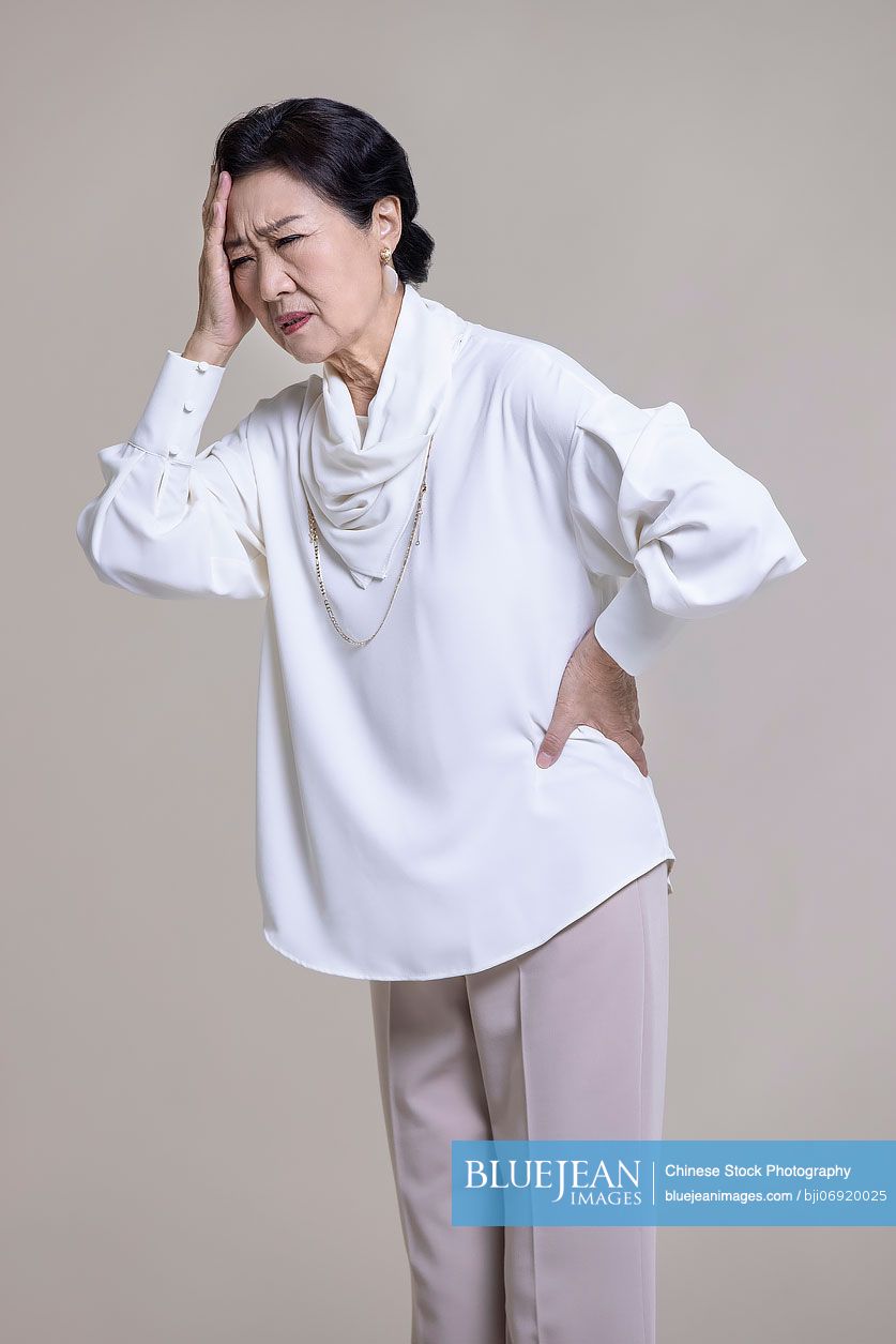 Senior Chinese woman feeling unwell