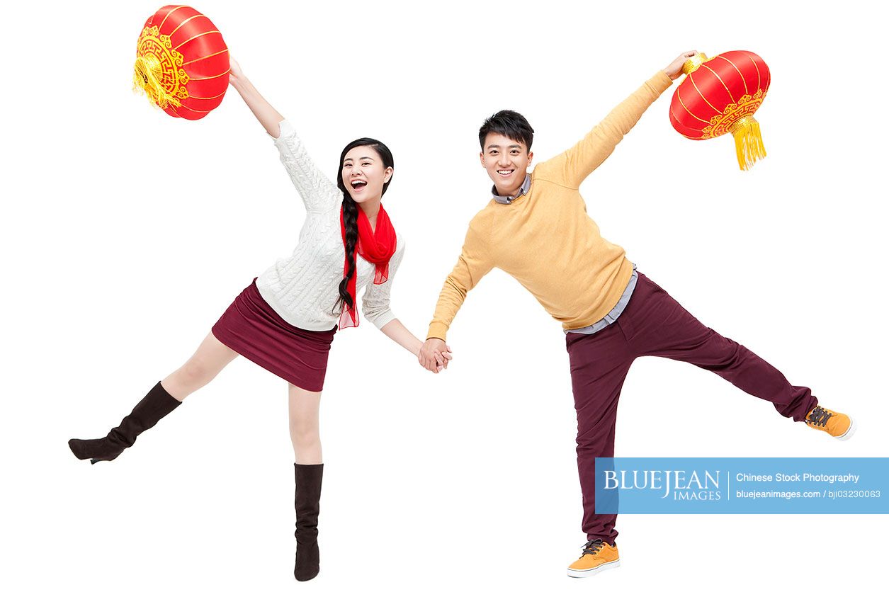 Sweet young Chinese couple holding traditional lantern