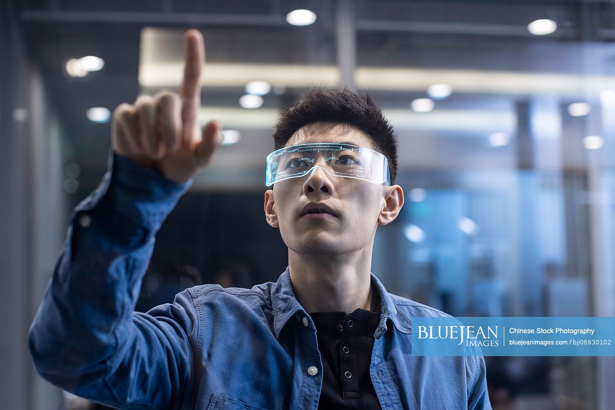 Young Chinese man wearing futuristic glasses