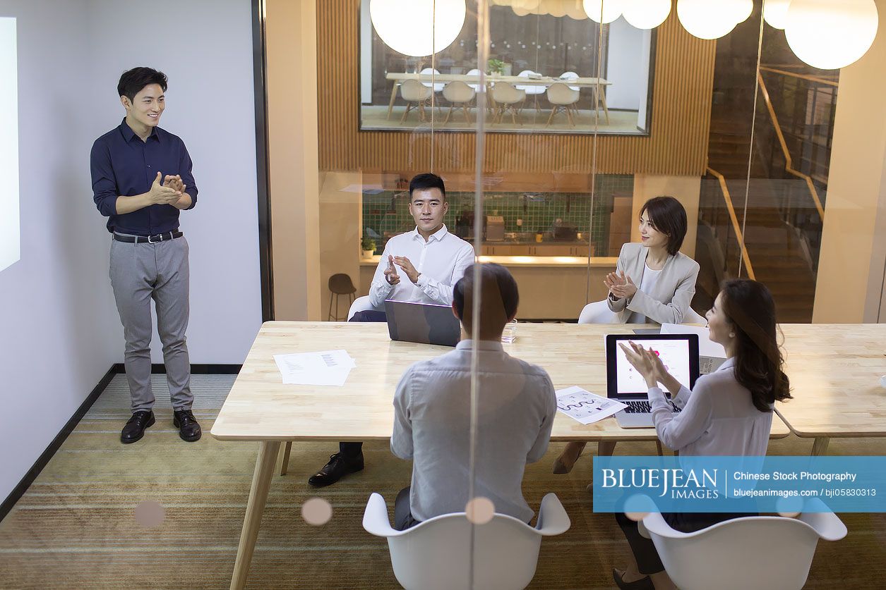 Chinese business people having meeting in board room 