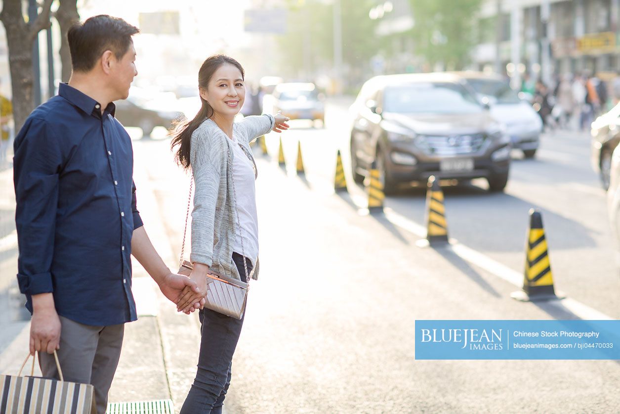 Happy mature Chinese couple shopping