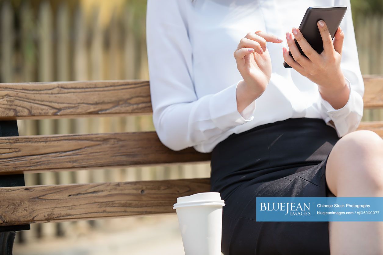 Young Chinese businesswoman using smart phone