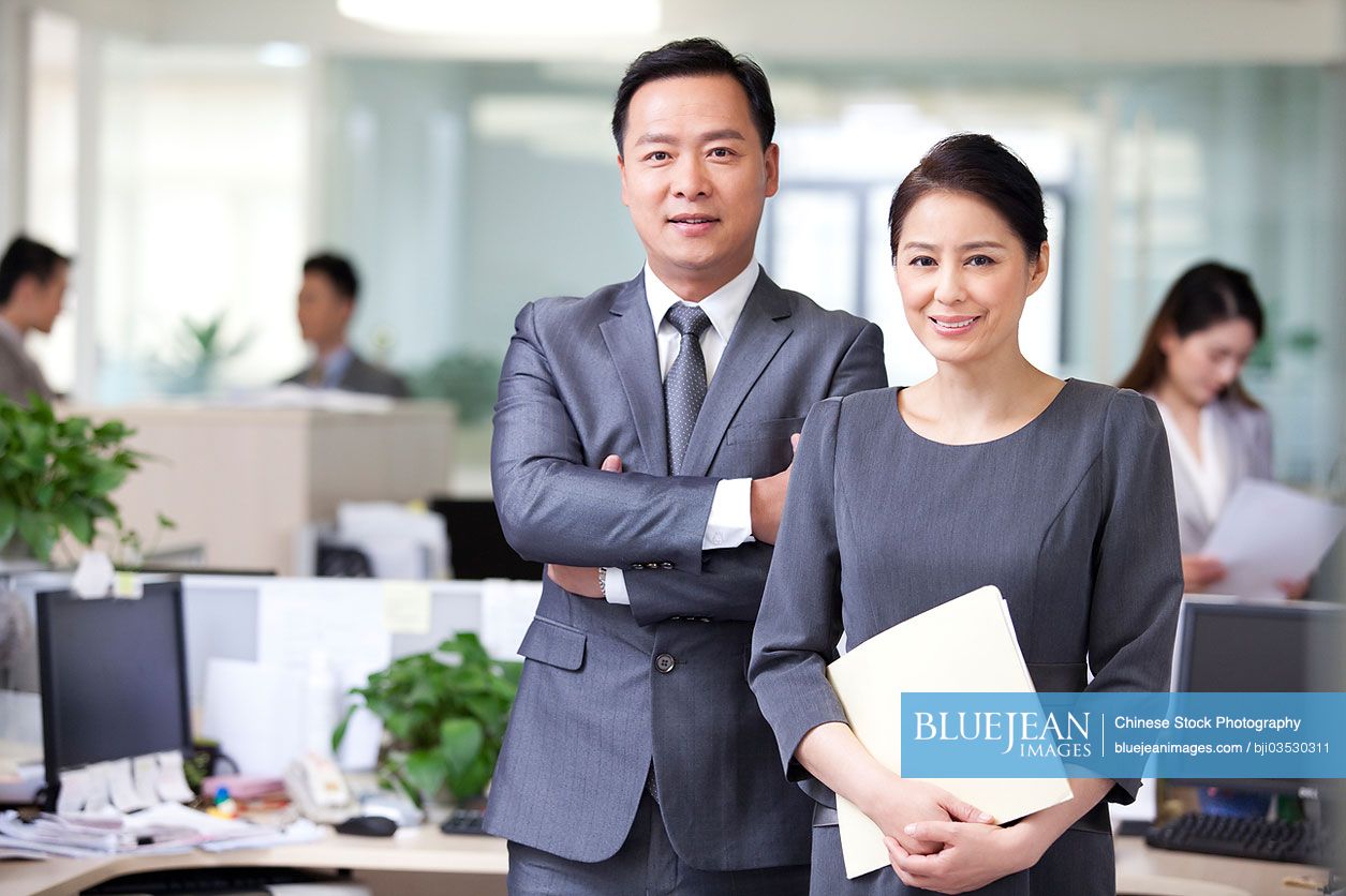 Portrait of mature Chinese businessman and businesswoman