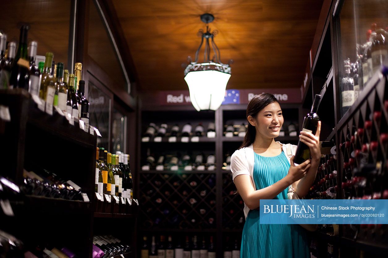 Young Chinese woman shopping in cellar