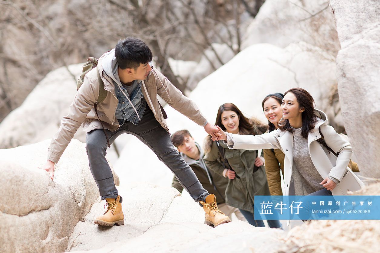 Happy young Chinese friends enjoying winter outing