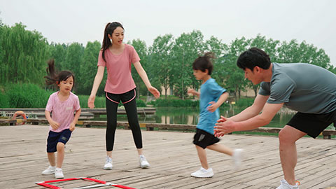 A young family works out in the park, staying active and healthy