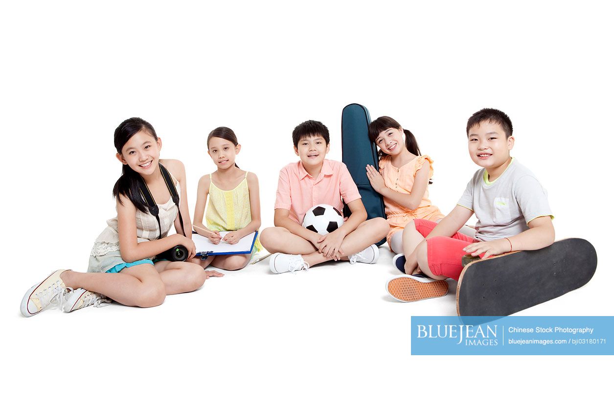 Merry Chinese children sitting on the floor and their leisure hobbiesHighres stock photo for