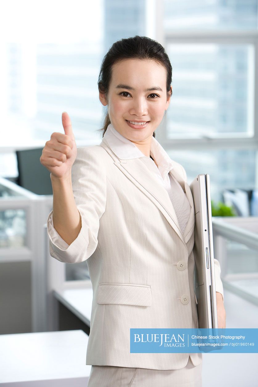 Chinese office worker giving thumbs up