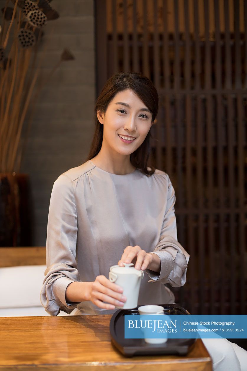 Young Chinese woman drinking tea