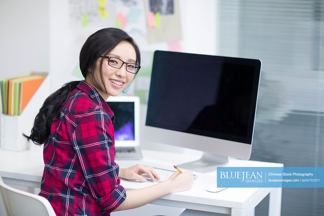 Young Chinese woman working in office