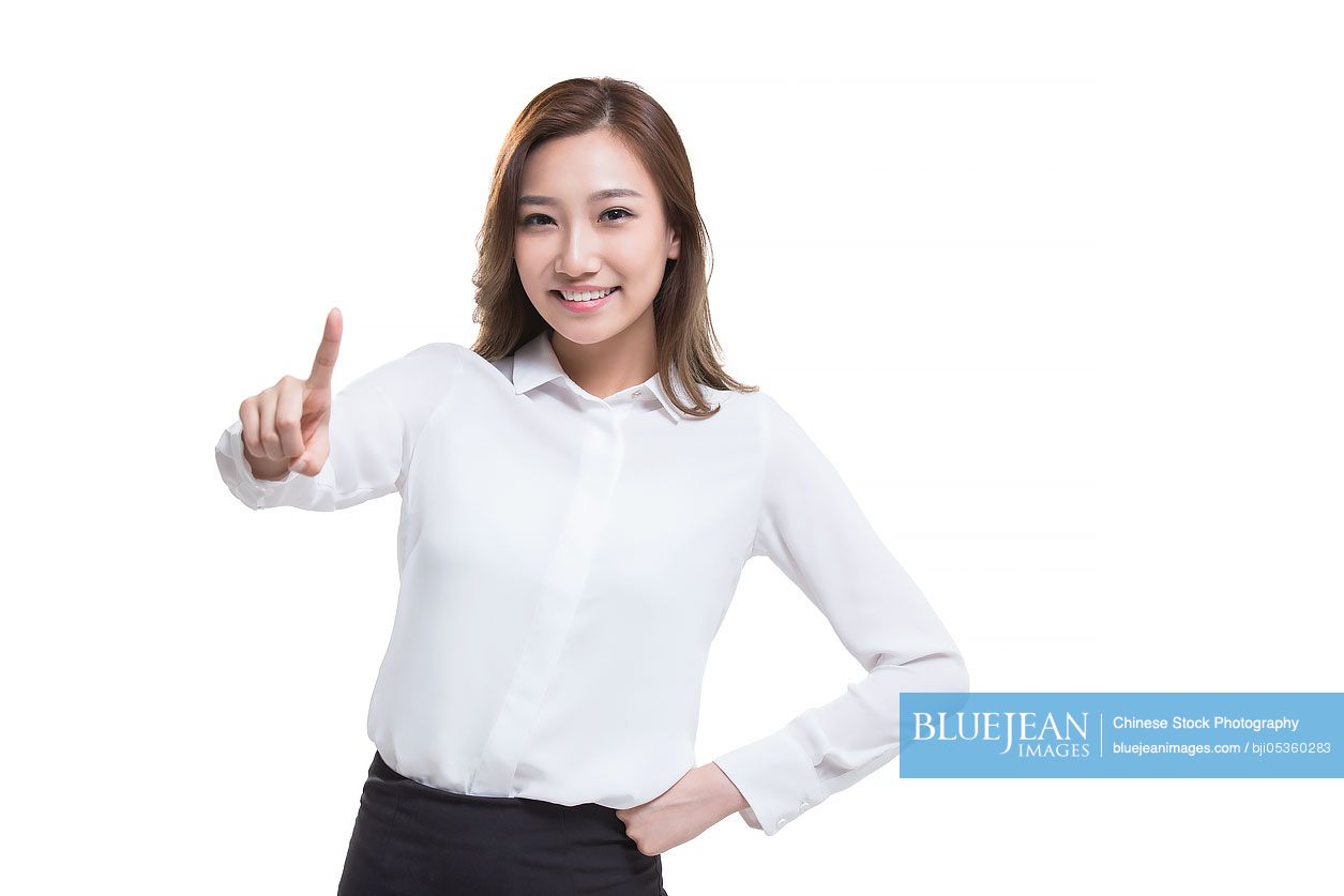 Confident young Chinese businesswoman pointing