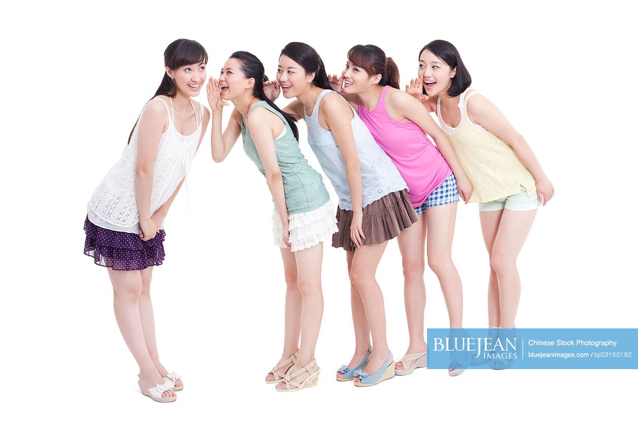 Best female Chinese friends whispering in a rowHighres stock photo
