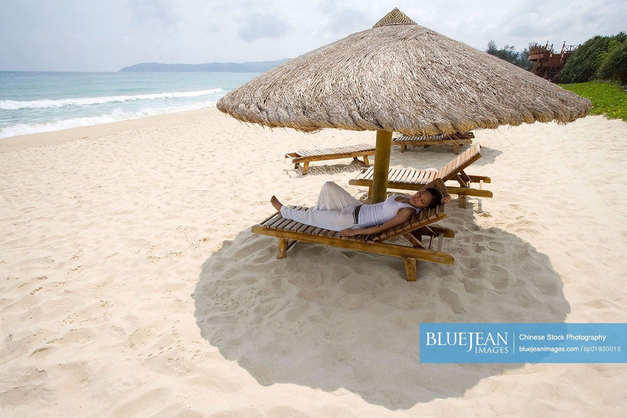 Young Chinese woman relaxing on the beach