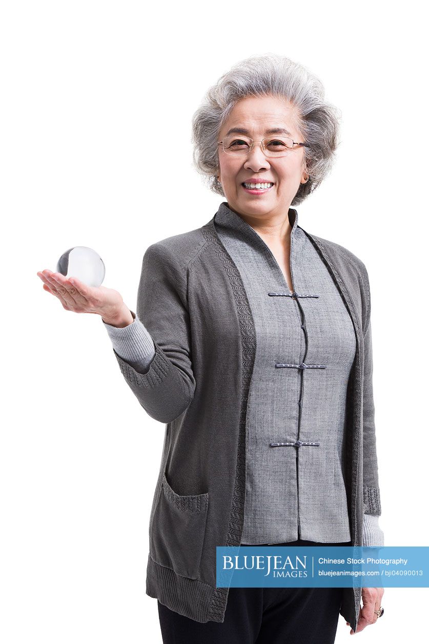 Senior Chinese woman with crystal ball