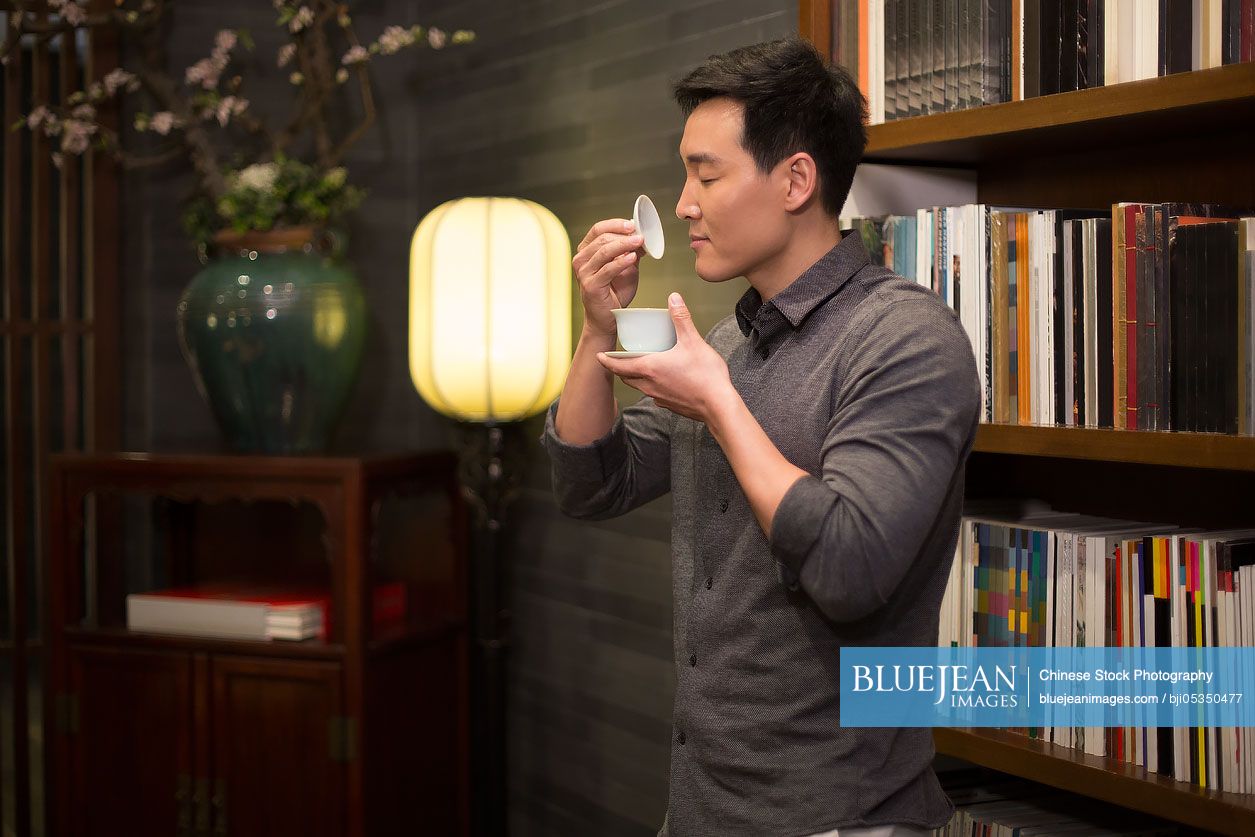 Mid adult Chinese man drinking tea