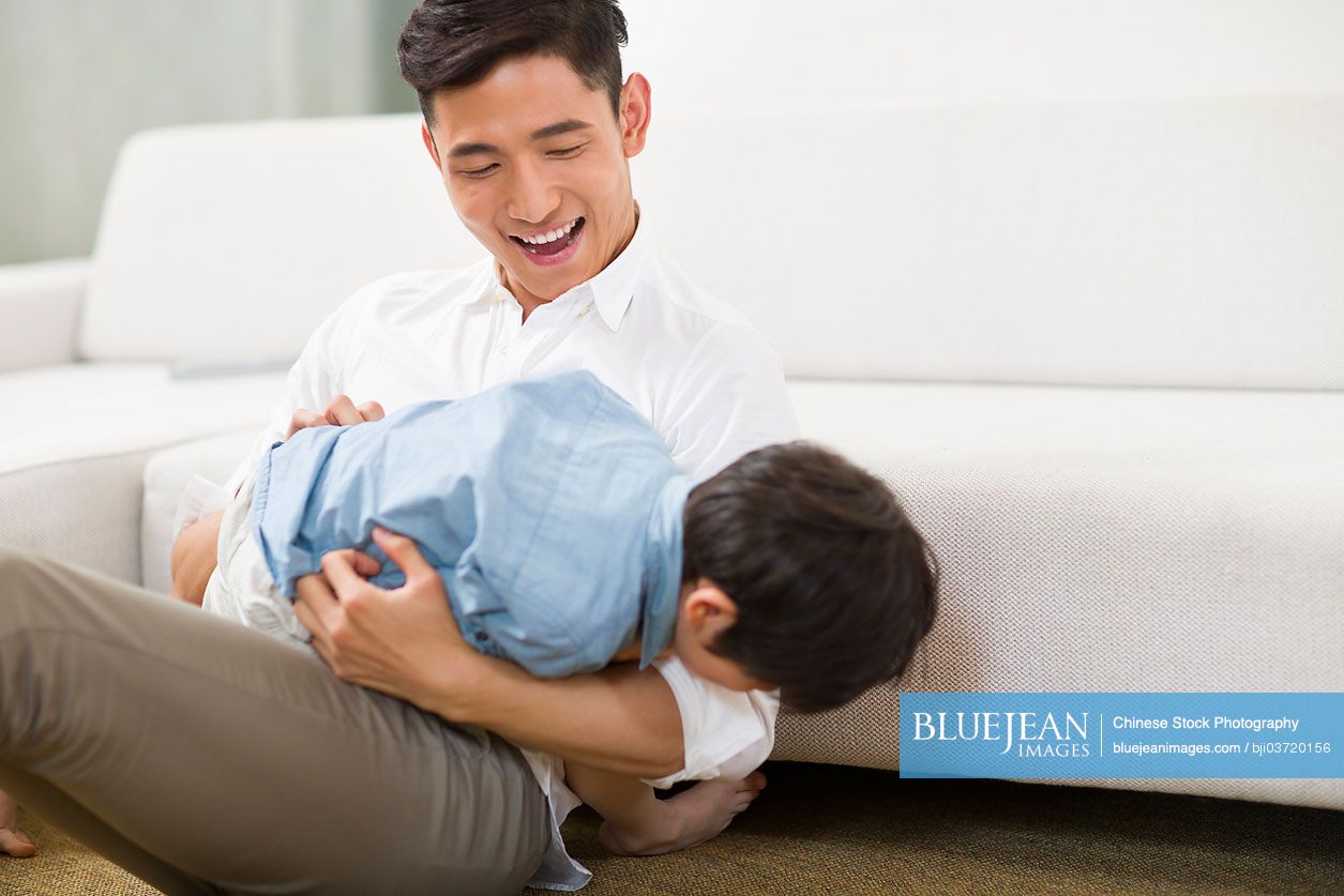 Chinese father and son in living room