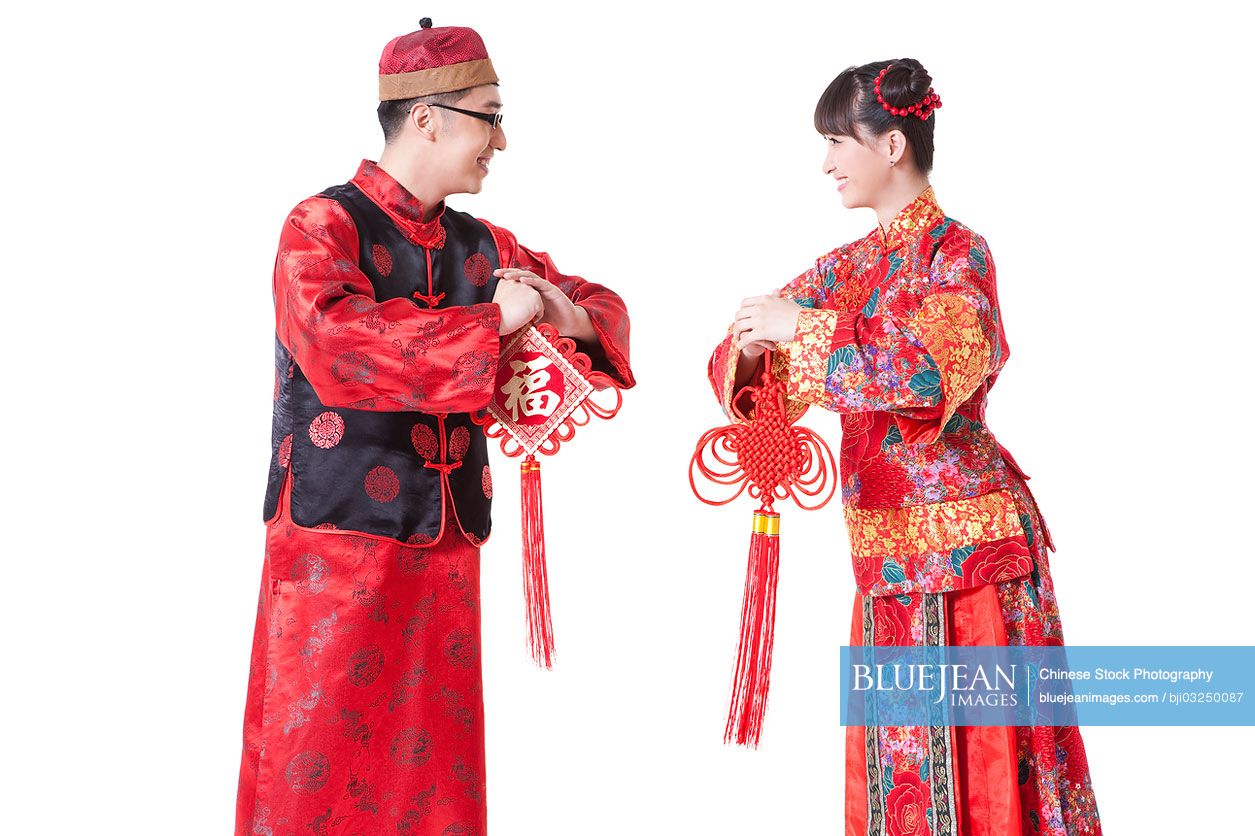 Young couple in traditional clothing greeting for Chinese New Year