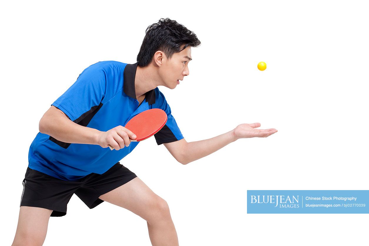 Chinese table tennis player gets ready to serve the ball