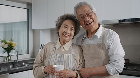 Cheerful senior Chinese couple cooking in kitchen,4K