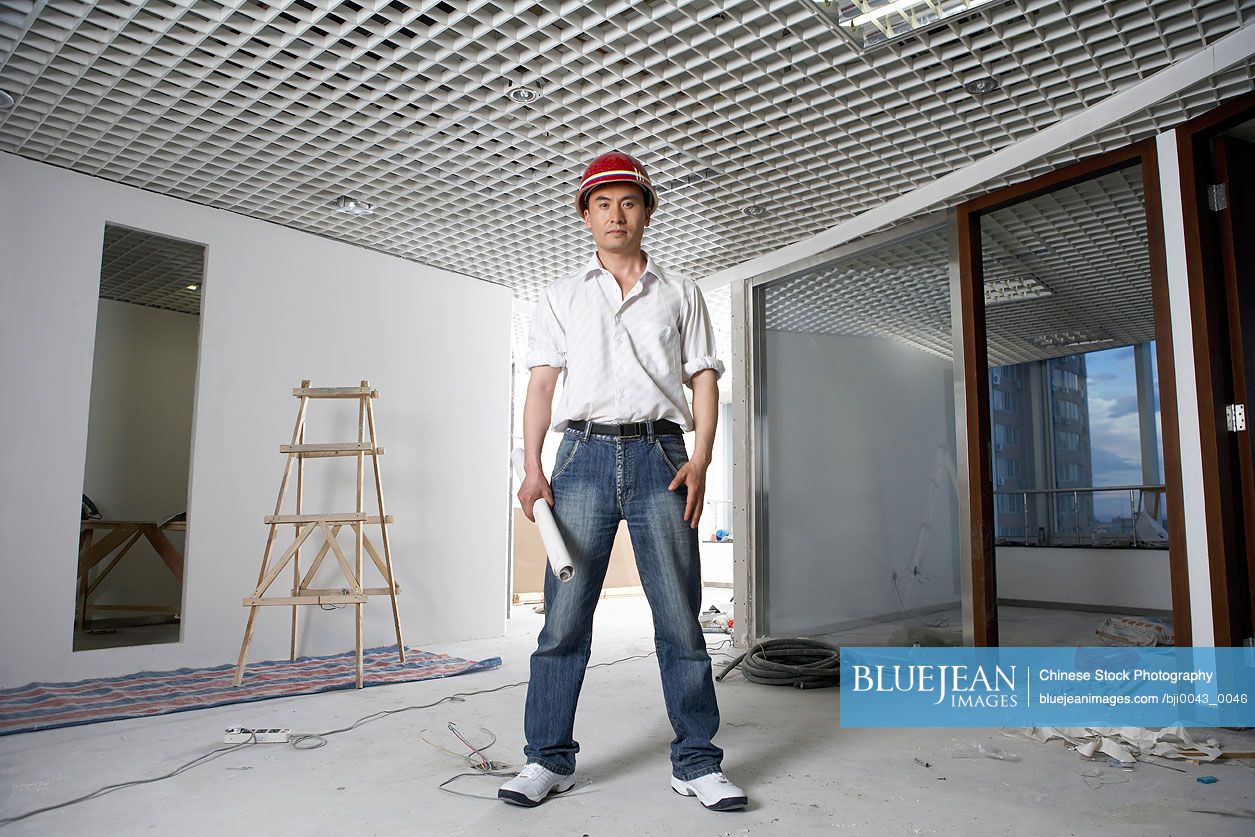 Chinese Man In Construction Site Wearing A Hard Hat