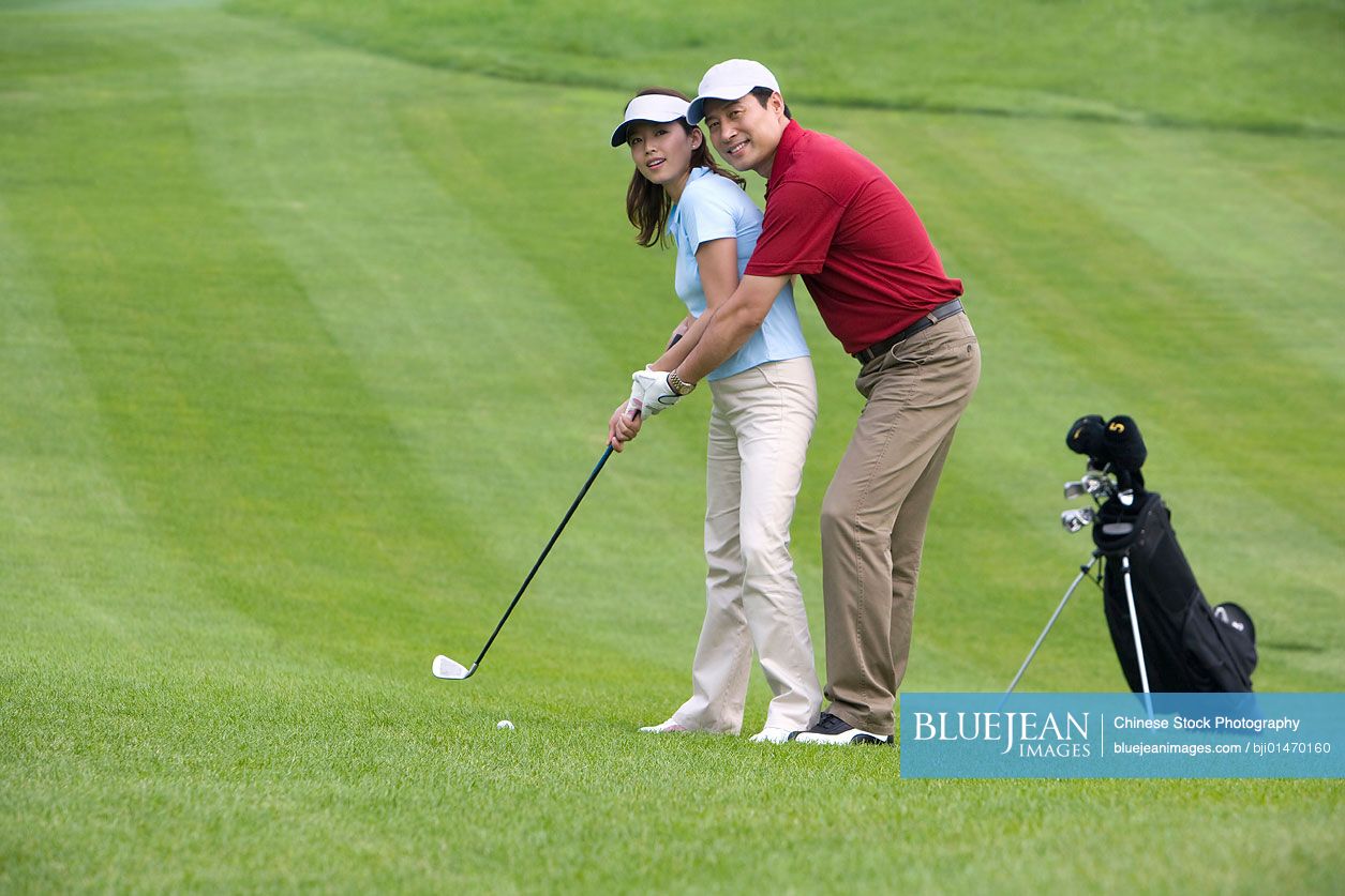 Chinese golf coach teaching golf