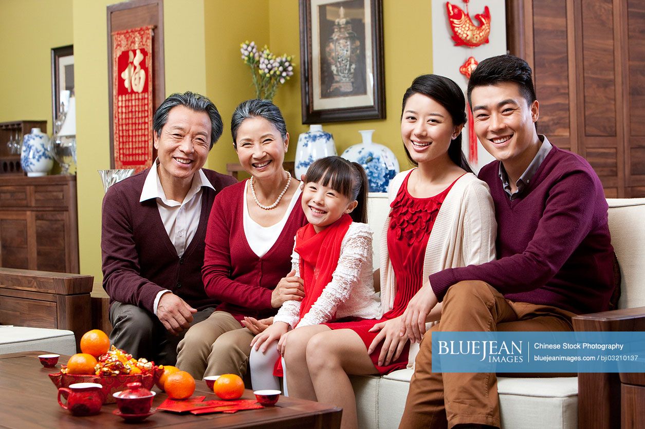 Happy family sitting in sofa during Chinese New Year