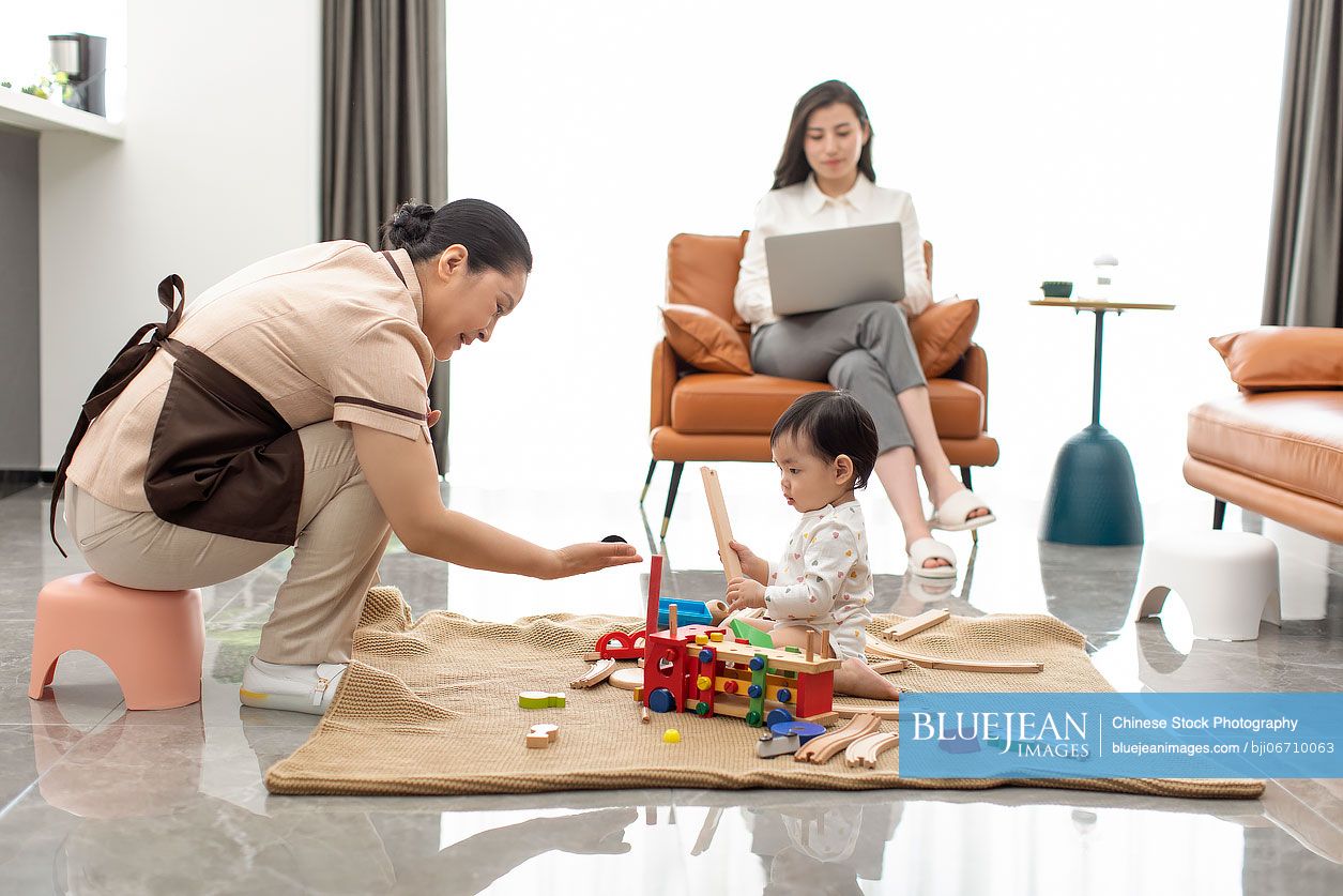 Chinese nanny taking care of baby girl