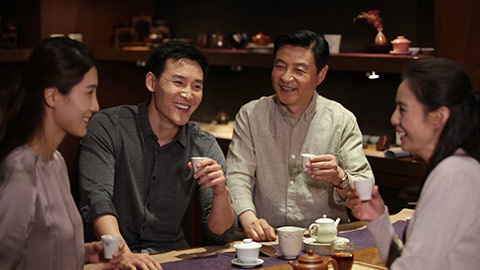 Happy Chinese family drinking tea together,HD