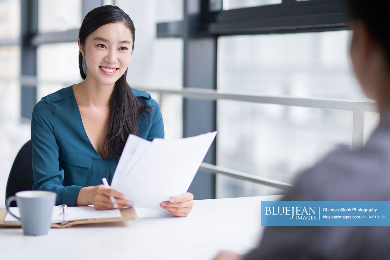 Young Chinese businesswoman conducting job interview