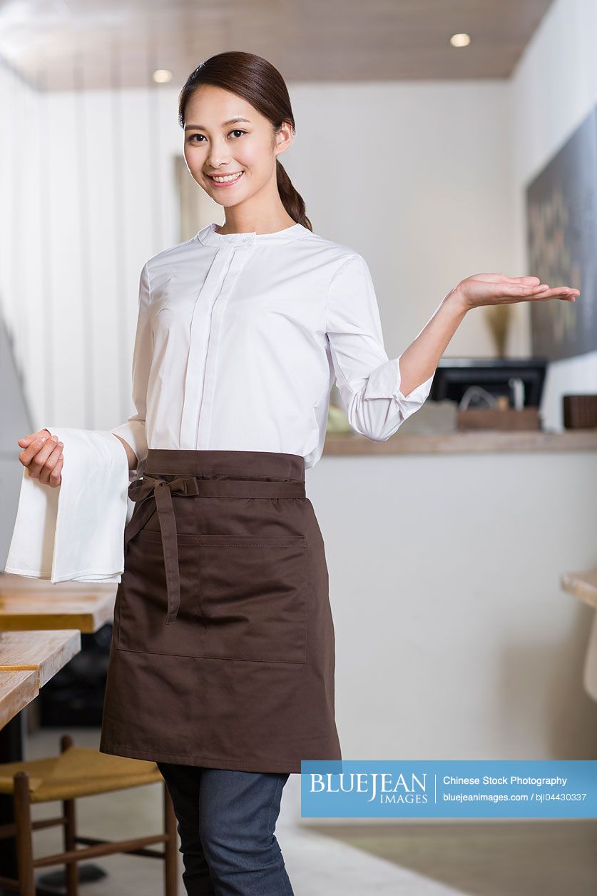 Chinese waitress standing in restaurant