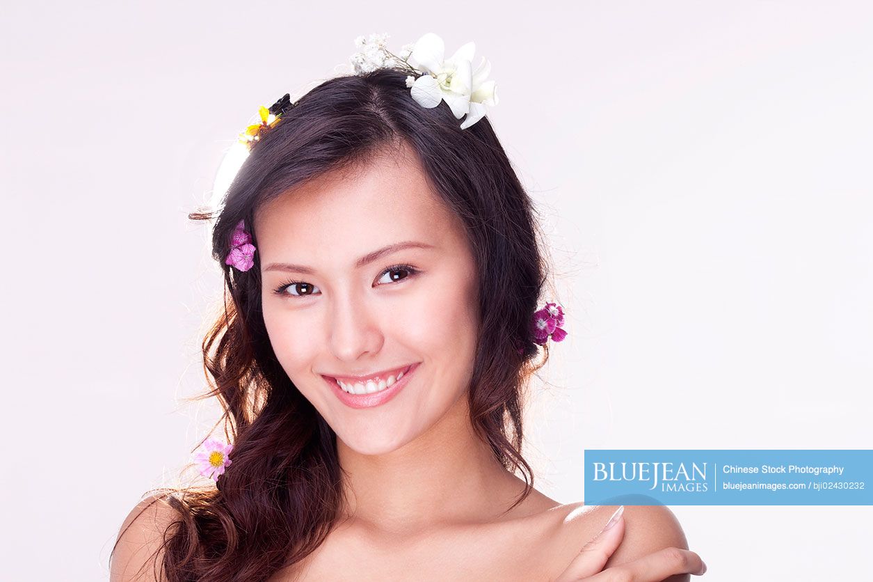Portrait of a beautiful young Chinese woman with flowers in her hair