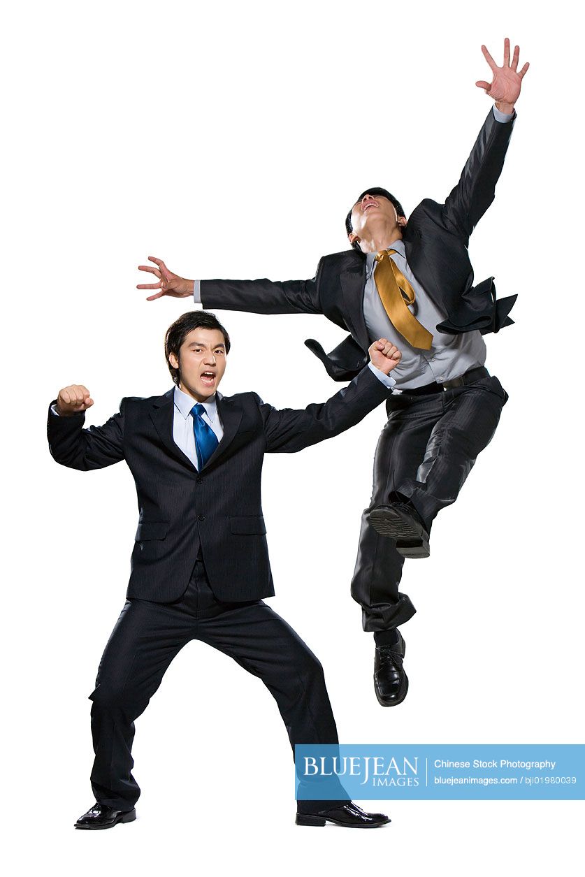 Two Chinese businessmen fighting on white background