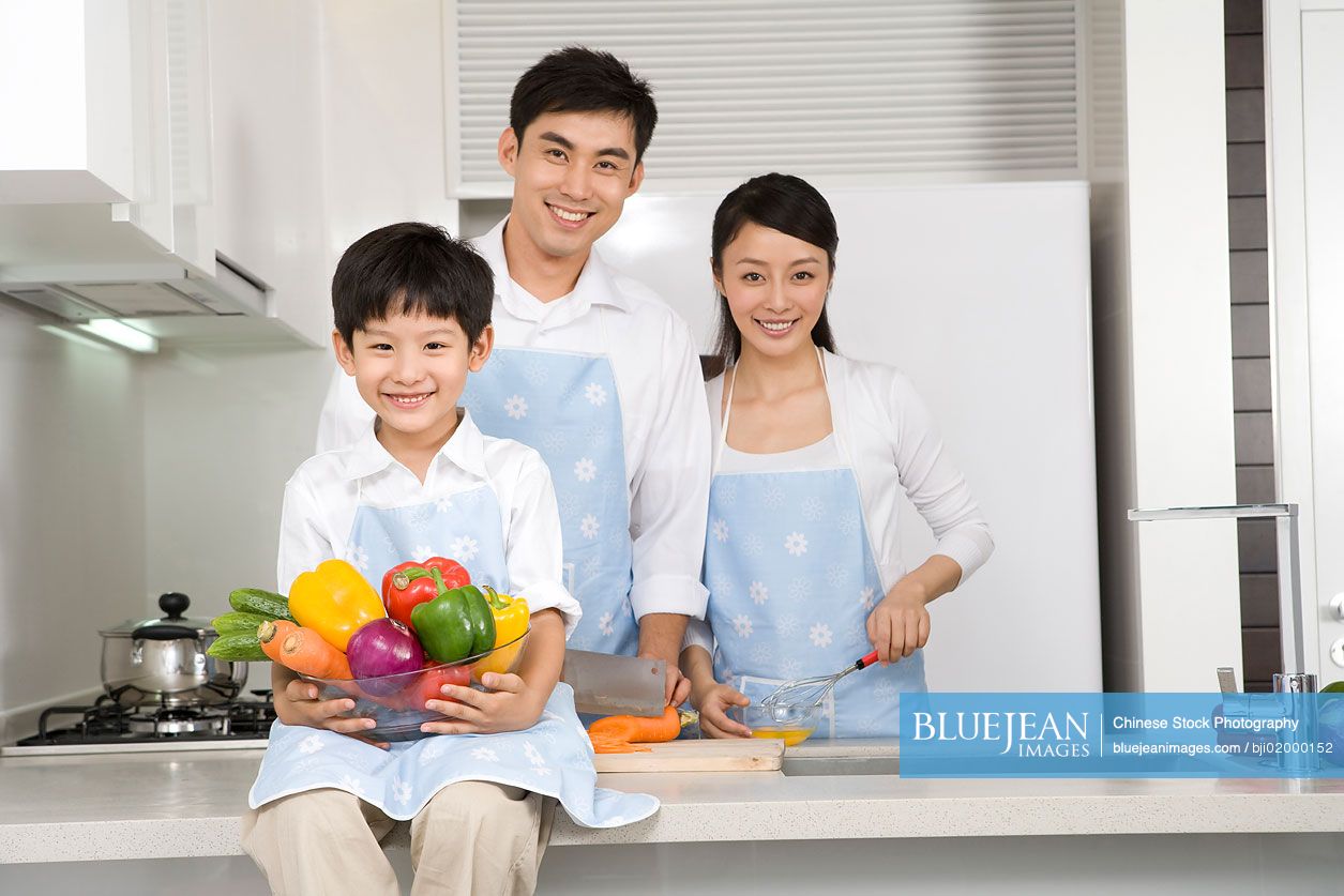 Chinese family preparing food in kitchen