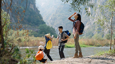 Happy young Chinese family having fun outdoors