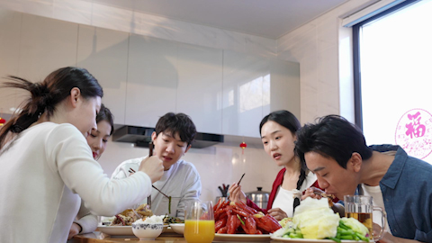 Young friends gathered around the table for a meal