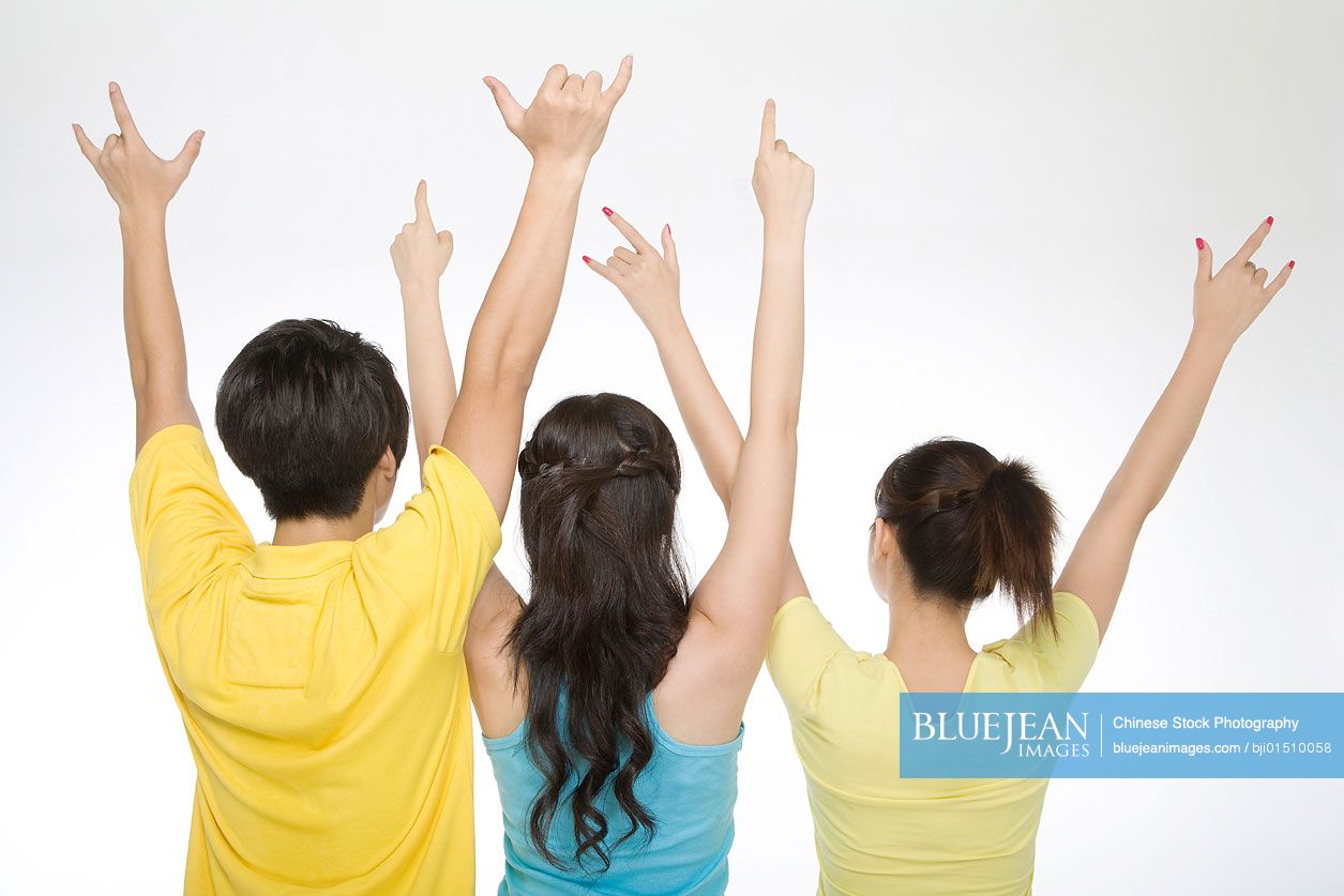 Three young Chinese people celebrating
